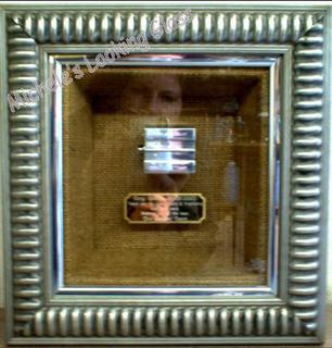 Two silver frames, third inner box frame and mountboard covered with material